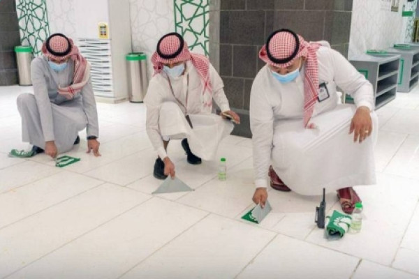 Social distancing stickers from all over Grand Mosque is being removed